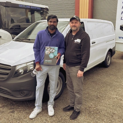 Steve standing next to customer after selling van
