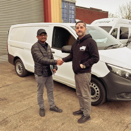 Steve shaking hands with  Premakumar Thurairatnam after selling a used van