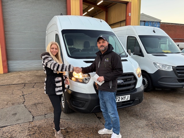 Steve from all van sales shaking hands with Rodica after selling her a van